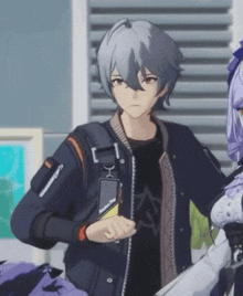 a boy with gray hair is wearing a black jacket and a black shirt with the letter a on it