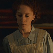a close up of a woman wearing an apron