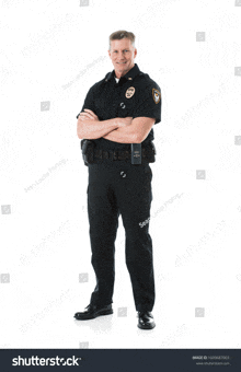 a police officer is standing with his arms crossed and smiling on a white background .
