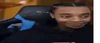 a man is smiling while sitting in a gaming chair .