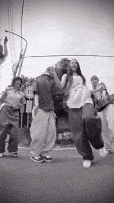 a group of people are dancing in front of a sign that says 15 on it