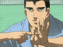 a man in a blue shirt is pointing his finger at something
