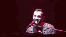 a man singing into a microphone on a stage