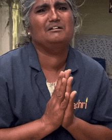 a woman wearing a blue shirt that says athri