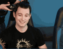 a man with a black shirt that says play the positive
