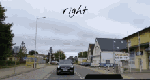 a car is driving down a street and the word right is on the bottom