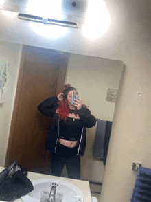 a woman taking a selfie in front of a mirror that says ' calvin klein ' on it