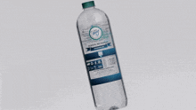 a bottle of blue haze water is splashing in the water