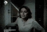 a woman is running in a dark room with the words oyle bir geçer zaman ki written on the bottom