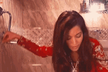 a woman in a red dress is sitting in a bathtub