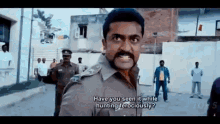 a man in a police uniform is talking to another man while standing on a street .