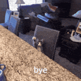 a cat standing on a chair with the word bye written on the counter