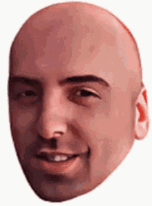 a bald man 's face is smiling and looking at the camera .