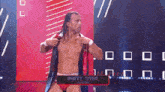 a wrestler named rhett titus is standing on stage