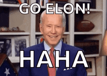 a man in a suit and tie is laughing and says `` go elon ! hahaha '' .