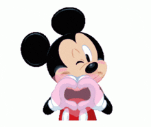 a cartoon mickey mouse making a heart shape with his hands