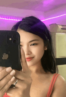 a woman is taking a picture of herself with her phone