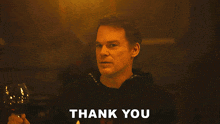a man holding a glass of wine with the words " for letting me in " behind him