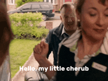 a woman holding a man 's hand with the words hello my little cherub behind her