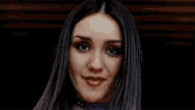 a close up of a woman 's face with a blue choker around her neck