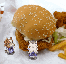 a chicken sandwich with sesame seeds and french fries on a table