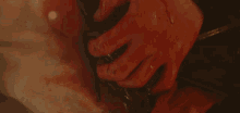 a close up of a person 's hands holding a piece of food