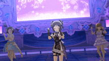 a group of anime girls are dancing on a stage in front of a large screen