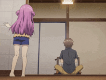 a girl with purple hair stands next to a man sitting on the floor