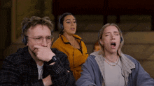 a group of people wearing headphones are singing