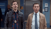 two men are standing next to each other and one has a badge on his neck that says 18