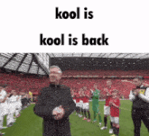 a man stands on a soccer field with the words " kool is kool is back "