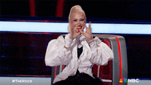 a woman sitting in a chair with a nbc logo in the corner