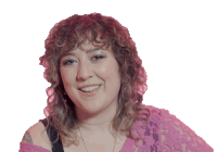 a woman with curly hair is smiling and wearing a pink shirt