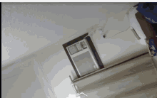 a room with a window air conditioner and a blue bag that says ' ice cream ' on it