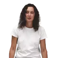 a woman with curly hair wearing a white t-shirt looks at the camera