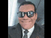 a man in a suit and tie wearing sunglasses