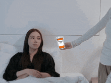 a woman laying in bed with a sticker of a bottle of anti-depressant pills