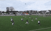 a group of soccer players are playing on a field with the capcut logo in the corner