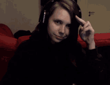 a young girl wearing headphones looks at the camera