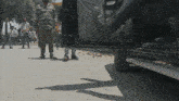 a man in a striped shirt is standing next to a car