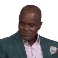 a man wearing a green suit and a pink shirt