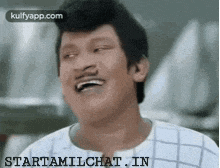 a man with a mustache is laughing with the website starttamilchat.in in the background