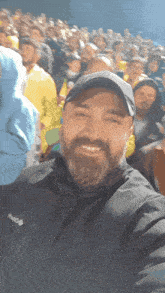 a man with a beard wearing a black jacket with the word columbia on it
