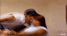 a man and a woman are kissing each other in a blurry photo .