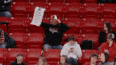 a man in a seattle shirt is holding up an eye test chart