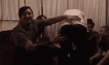 a group of people are sitting on a couch in a living room .