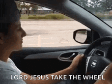 a man is driving a car with the words lord jesus take the wheel above him .