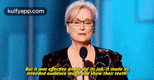a woman is giving a speech in front of a microphone and says but it was effective and it did its job .