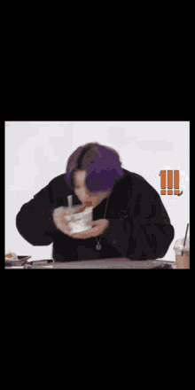 a person with purple hair is eating from a bowl .