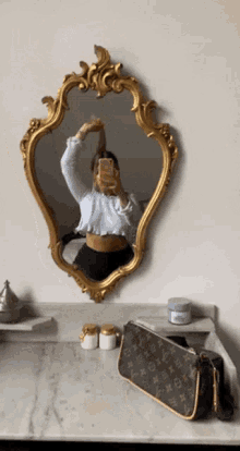 a woman takes a picture of herself in a mirror
